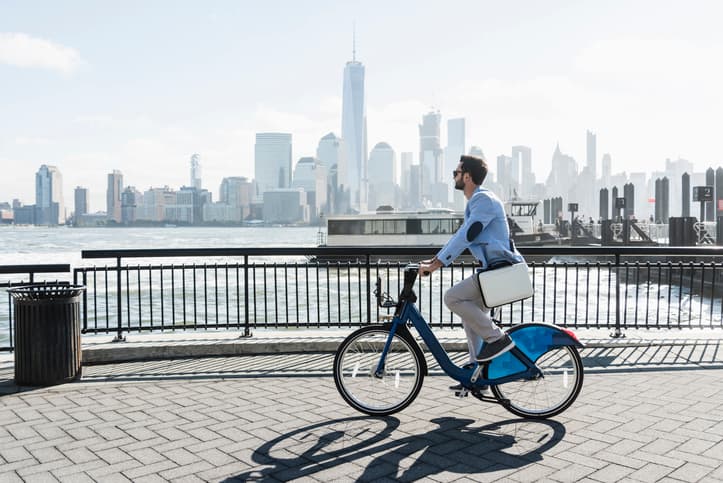 Young city male rides his bike to work a on a sunny day