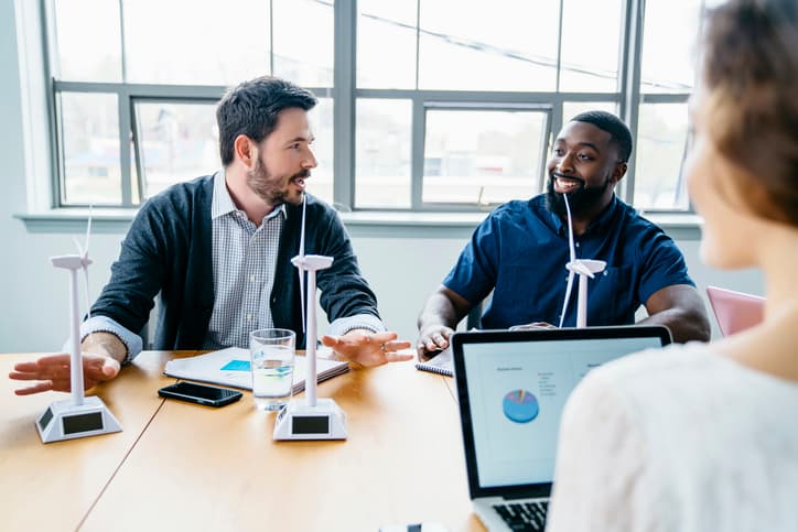 Team in office setting discussing wind turbines